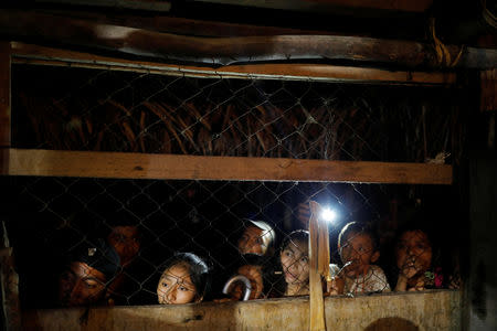 Friends and family members attend a service for Jakelin Caal, a 7-year-old girl who handed herself in to U.S. border agents earlier this month and died after developing a high fever while in the custody of U.S. Customs and Border Protection, at her home village of San Antonio Secortez, in Raxruha, Guatemala December 24, 2018. REUTERS/Carlos Barria