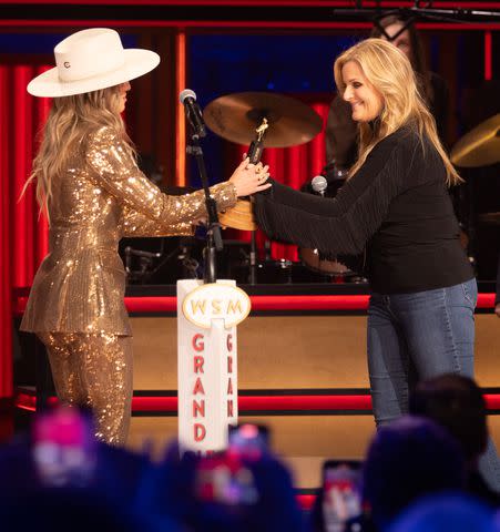 <p>Chris Hollo/Grand Ole Opry</p> Lainey Wilson being welcomed into the Grand Ole Opry by Trisha Yearwood