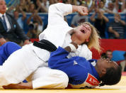 Britain's Gemma Gibbons celebrates after defeating France's Audrey Tcheumeo (blue) in their women's -78kg semi-final B judo match at the London 2012 Olympic Games August 2, 2012. REUTERS/Darren Staples (BRITAIN - Tags: OLYMPICS SPORT JUDO TPX IMAGES OF THE DAY) 