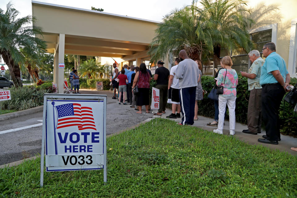 Voters line up at a community center in Hollywood, Fla.