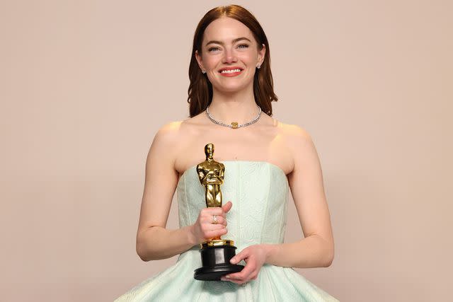 <p>John Shearer/WireImage</p> Emma Stone poses in the press room during the 96th Academy Awards