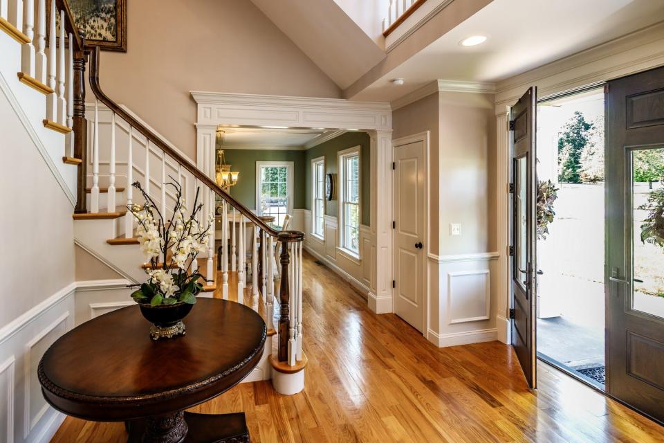 The two-story open staircase foyer leads to an open overlook on the second floor.