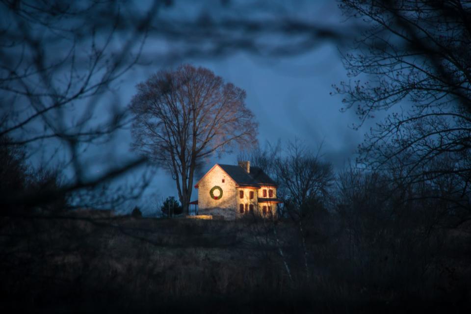 The house in the center of Longwood's meadow all lit up for A Longwood Christmas in 2018.