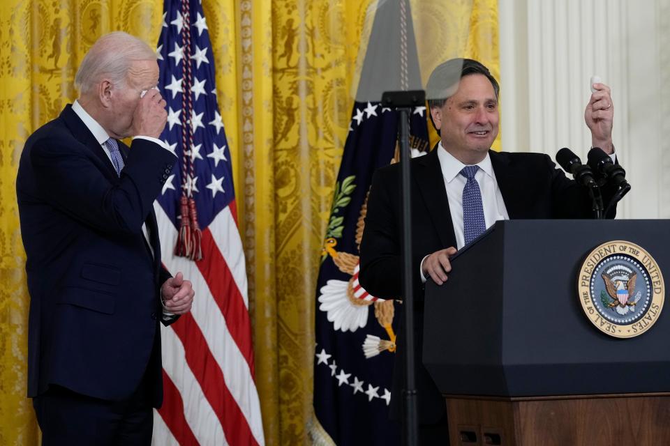 President Joe Biden wipes his eyes as outgoing White House chief of staff Ron Klain, holds up a rock, in the East Room of the White House in Washington, Wednesday, Feb. 1, 2023. (AP Photo/Susan Walsh)