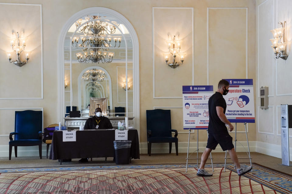 A man enters a COVID-19 testing site inside a hotel ballroom.