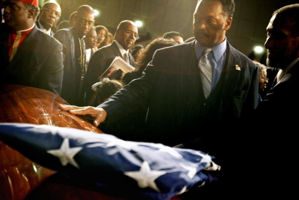 The Rev. Jesse Jackson touches the casket of Rosa Parks before the American flag was draped on the coffin on Wednesday, Nov. 2, 2005, at Greater Grace Temple in Detroit. Parks, 92, died Oct. 24, 2005 at her Detroit home. Far right is Art Featherstone,  former head of Detroit's NAACP. To the direct left of Jackson, is Rev. Charles Adms of Hartford Memorial Baptist Church in Detroit.Regina H. Boone/Detroit Free Press