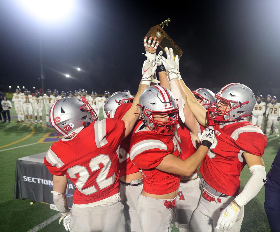 Canandaigua captains raise the Class A2 trophy after a 41-14 win over Spencerport.