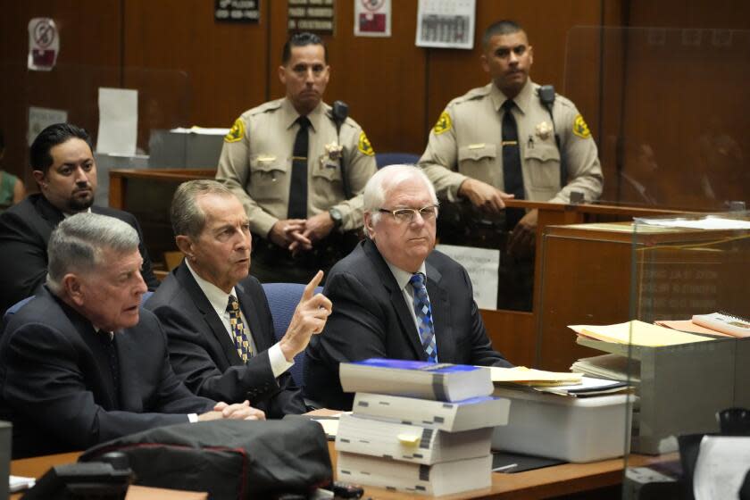 Orange County Superior Court Judge Jeffrey Ferguson, right, sits next to his attorneys John Drummond Barnett, left, and Paul Meyer during a hearing at the Clara Shortridge Foltz Criminal Justice Center, Tuesday, Aug. 15, 2023, in Los Angeles. The Southern California judge, Ferguson, charged with killing his wife during an argument while he was drunk, pleaded not guilty Tuesday, and his lawyer says it was an "accidental shooting." (AP Photo/Damian Dovarganes, Pool)