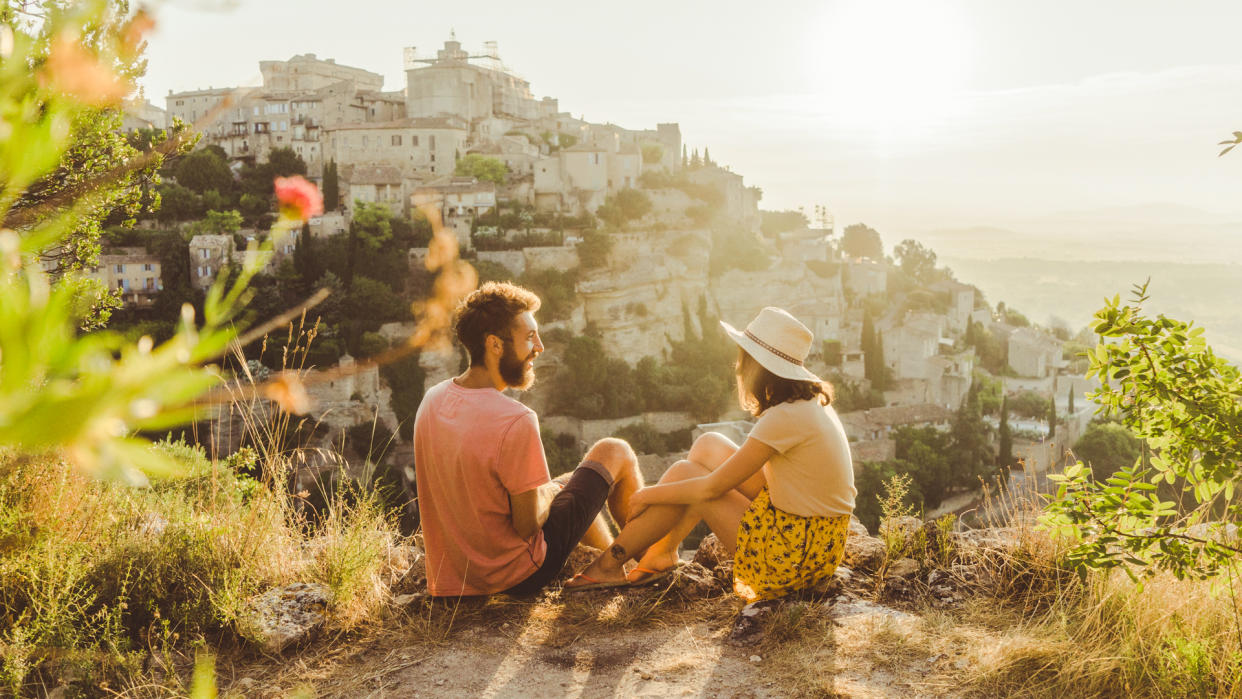 Young Caucasian woman and man looking at scenic view  of Gordes village in Provence.