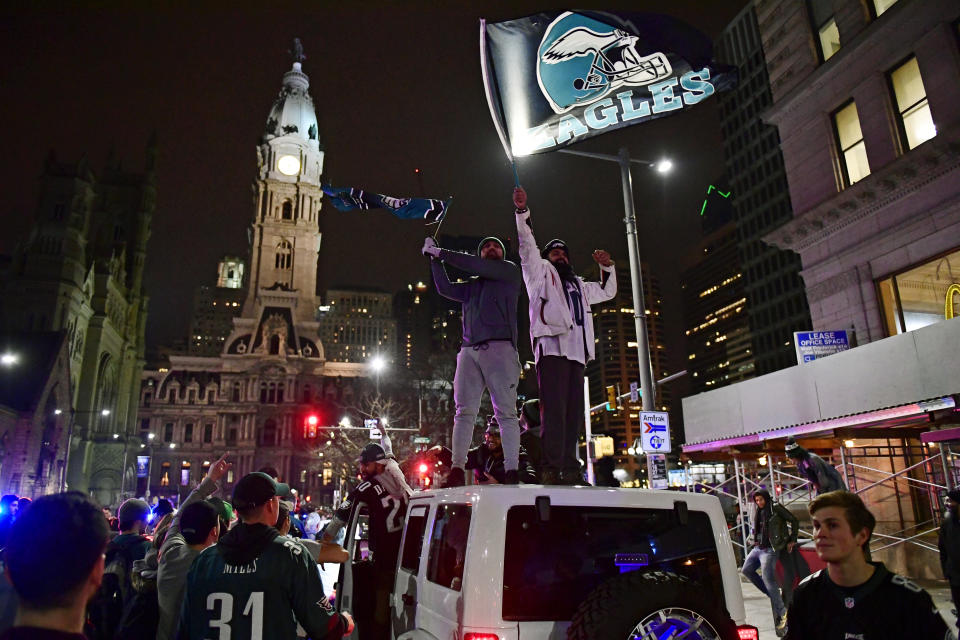 Philadelphia Eagles fans celebrate on top of cars on Broad Street. (Getty)