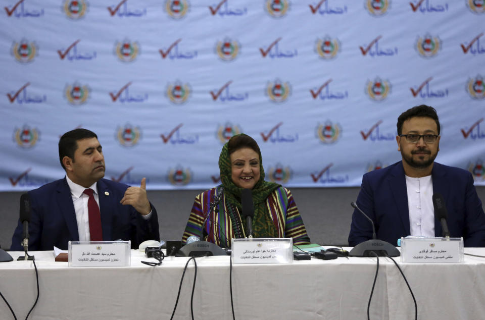 Hawa Alam Nuristani, chief of Election Commission of Afghanistan, center, speaks during a press conference at the Independent Election Commission office in Kabul, Afghanistan, Tuesday, Feb. 18, 2020. Afghanistan's independent election commission says President Ashraf Ghani has won a second term as president. The commission announced Tuesday that Ghani garnered 50.64% of the vote that took place on Sept. 28 last year to challenger and chief executive Abdullah Abdullah's 39.52%. (AP Photo/Rahmat Gul)