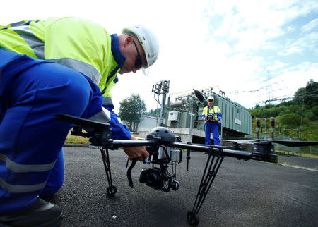 A worker maintains a drone which is used to survey high-voltage power lines of electric company Westnetz near Wilnsdorf, Germany, July 11, 2018. REUTERS/Ralph Orlowski