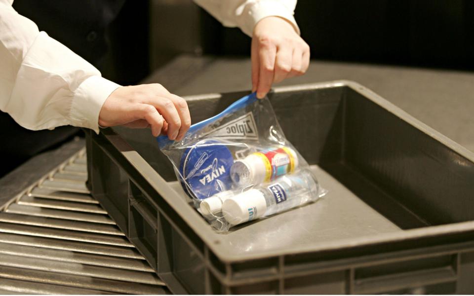 Someone puts liquid in a clear plastic bag during airport security checks