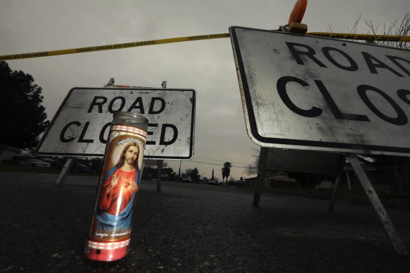 GOSHEN, CA - JANUARY 19, 2023 - - One lone candle stands as a memorial to the six people who were slain on a closed Harvest Avenue in Goshen on January 17, 2023. Law enforcement officials were continuing their investigation at the scene of a shooting. Local officials have called the slayings a targeted attack in the small Tulare County town. (Genaro Molina / Los Angeles Times)