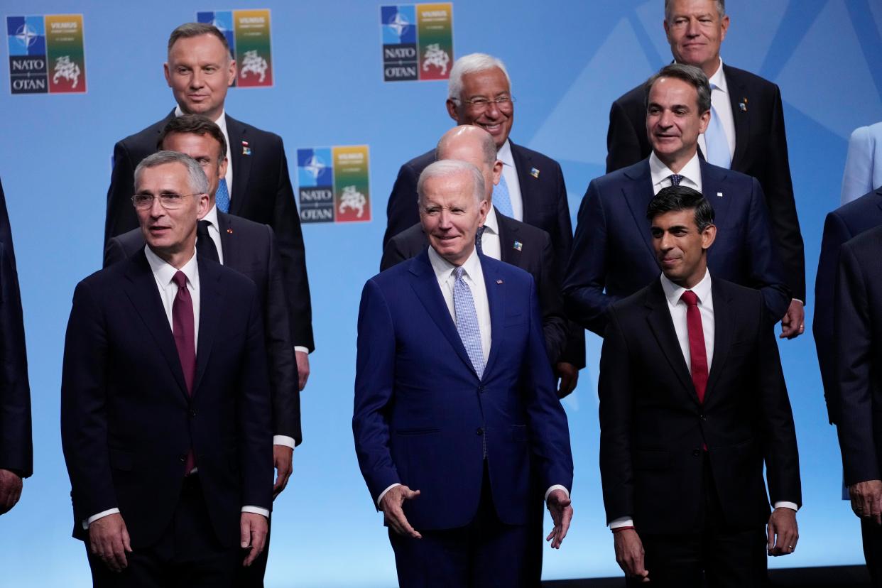 Front row from left, NATO Secretary General Jens Stoltenberg, President Joe Biden, and Britain's Prime Minister Rishi Sunak, second row from left French President Emmanuel Macron, German Chancellor Olaf Scholz, and Greek Prime Minister Kyriakos Mitsotaki, third row from left are, Polish President Andrzej Duda, Portugal's Prime Minister Antonio Costa and Romania's President Klaus Werner Iohannis, reacts at the conclusion of the family photo at the NATO summit in Vilnius, Lithuania, Tuesday, July 11, 2023. (AP)