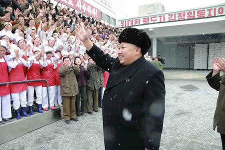 North Korean leader Kim Jong Un waves to workers during a visit to the Pyongyang Children's Foodstuff Factory in this undated photo released by North Korea's Korean Central News Agency (KCNA) in Pyongyang December 16, 2014. REUTERS/KCNA