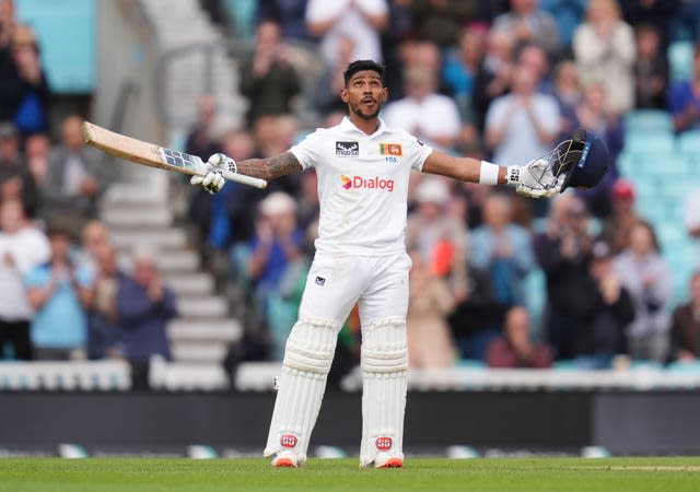 Sri Lanka’s Pathum Nissanka celebrates reaching his century with his arms outstretched