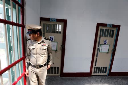 A guard stands in the long-term sentence zone inside Klong Prem high-security prison in Bangkok, Thailand July 12, 2016. The number 5 in the doors indicates the number of prisoners who sleep in each cell. REUTERS/Jorge Silva