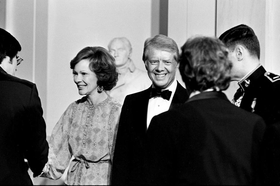 First Lady Rosalynn Carter and President Jimmy Carter are greeting guests in front of the Blue Room of the White House April 17, 1978 for their gala reception for members of the Country Music Association.