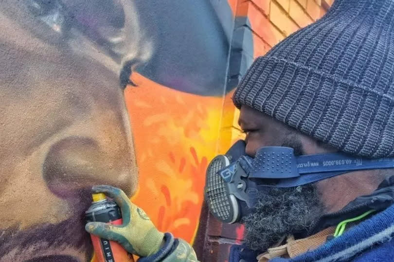 Artist Bunny with the new Benjamin Zephaniah mural in Handsworth