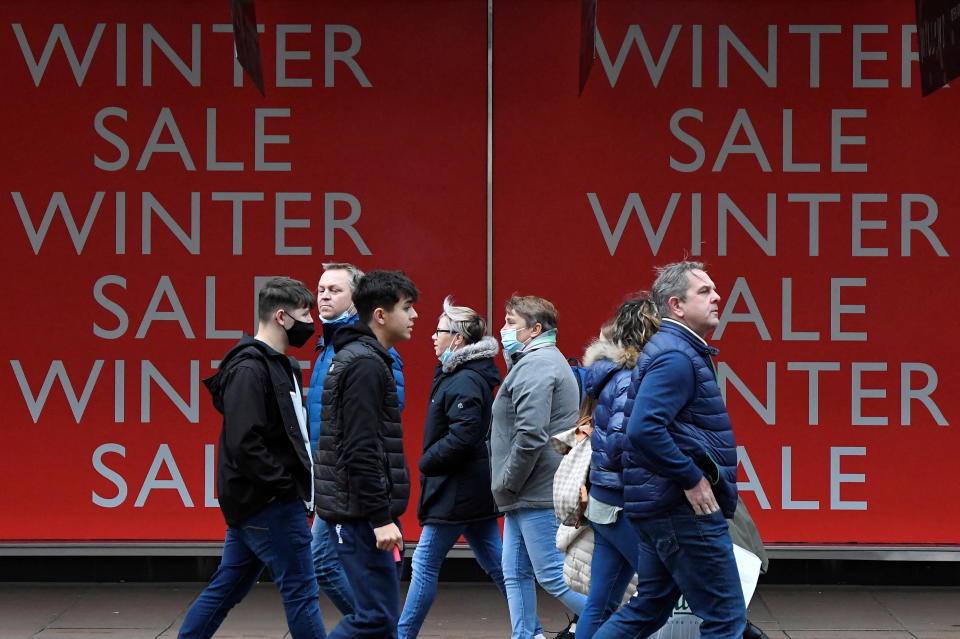 Shoppers walk past sale signs at a department store on Oxford Street in London, Britain, December 28, 2021. REUTERS/Toby Melville