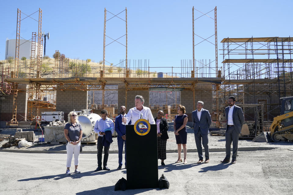 Governor Gavin Newsom, center, talks to reporters during a press conference at the construction site of a water desalination plant in Antioch, Calif., Thursday, Aug. 11, 2022. (AP Photo/Godofredo A. Vásquez)