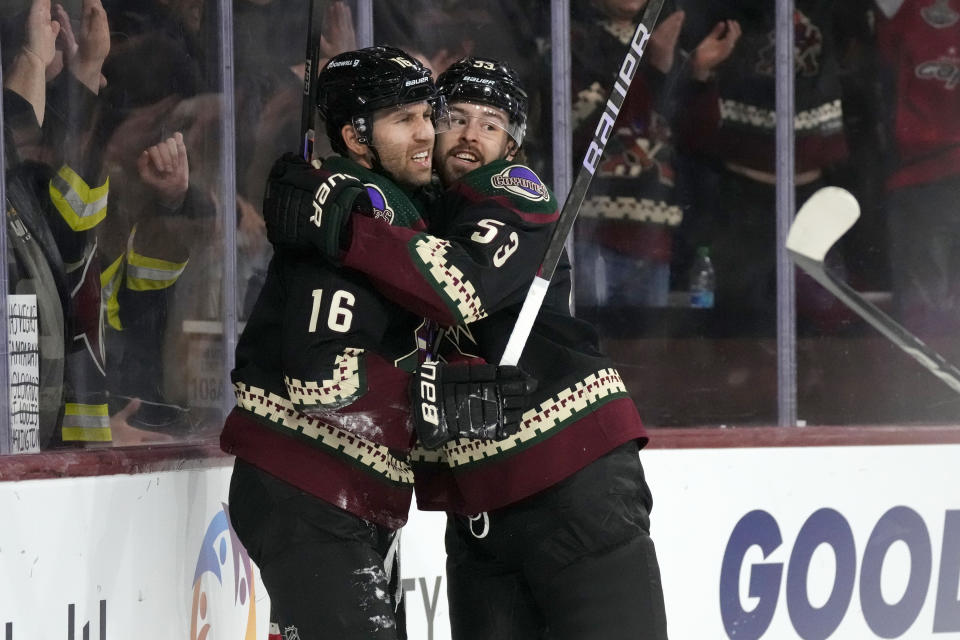 Arizona Coyotes left wing Jason Zucker (16) celebrates after his goal against the Washington Capitals with left wing Michael Carcone (53) during the first period of an NHL hockey game Monday, Dec. 4, 2023, in Tempe, Ariz. (AP Photo/Ross D. Franklin)