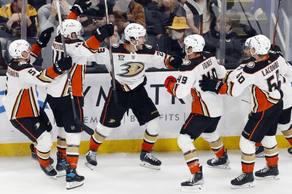 Anaheim Ducks' Mason McTavish (23) celebrates with teammates after his goal in overtime of an NHL hockey game against the Boston Bruins, Thursday, Oct. 26, 2023, in Boston. (AP Photo/Michael Dwyer)