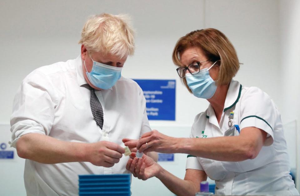 Prime Minister Boris Johnson Boris Johnson with advanced pharmacy technician Jane Hosea, during a visit to a vaccination centre in Northamptonshire (Peter Cziborra/Reuters/Pool) (PA Wire)