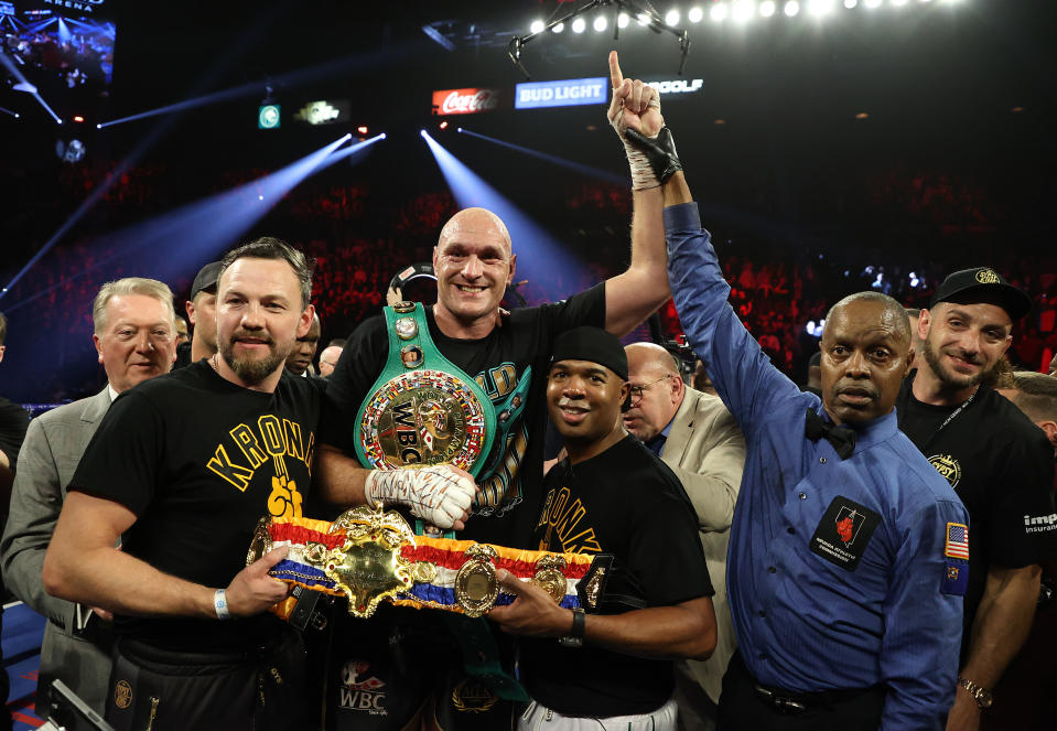 Tyson Fury celebrates his win with his teammates.