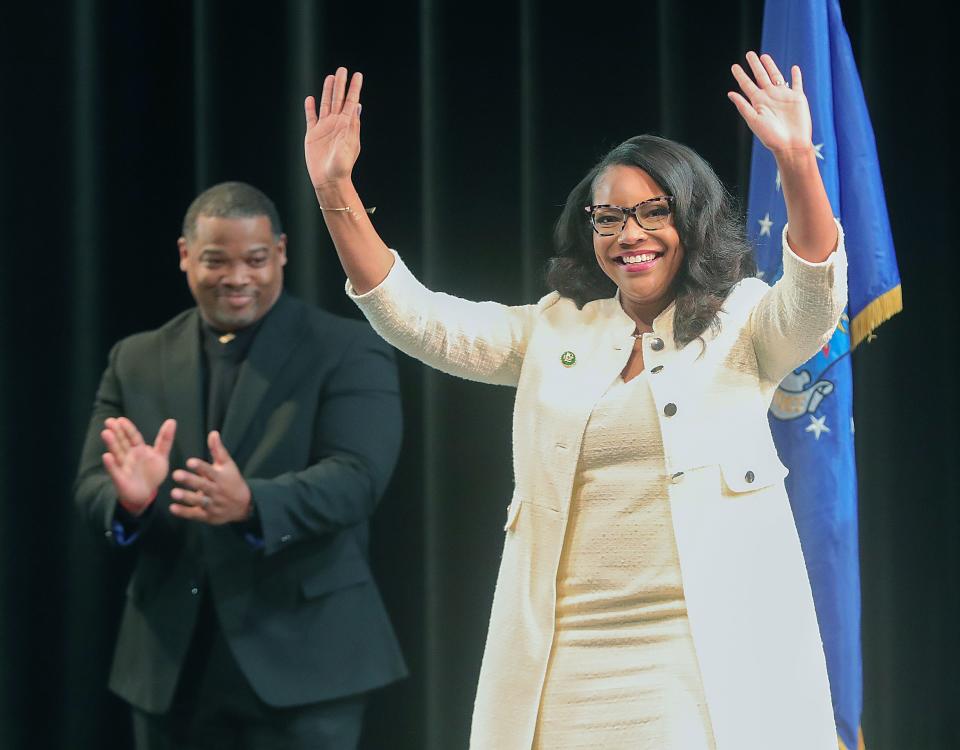 U.S. Rep. Emilia Sykes acknowledges the crowd before being sworn in Saturday at Firestone Community Learning Center in Akron. At left is Kevin Rushing, senior pastor of United Baptist Church.