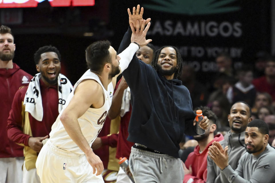 Cleveland Cavaliers' Darius Garland, center right, and Georges Niang, front left, celebrate after a three-point basket made by Niang during the second half of an NBA basketball game against the Washington Wizards, Friday, Jan. 5, 2024, in Cleveland. (AP Photo/Nick Cammett)