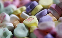 FILE - Colored "Sweethearts" candy is held in bulk prior to packaging at the New England Confectionery Company in Revere, Mass., on Jan. 14, 2009. (AP Photo/Charles Krupa, File)