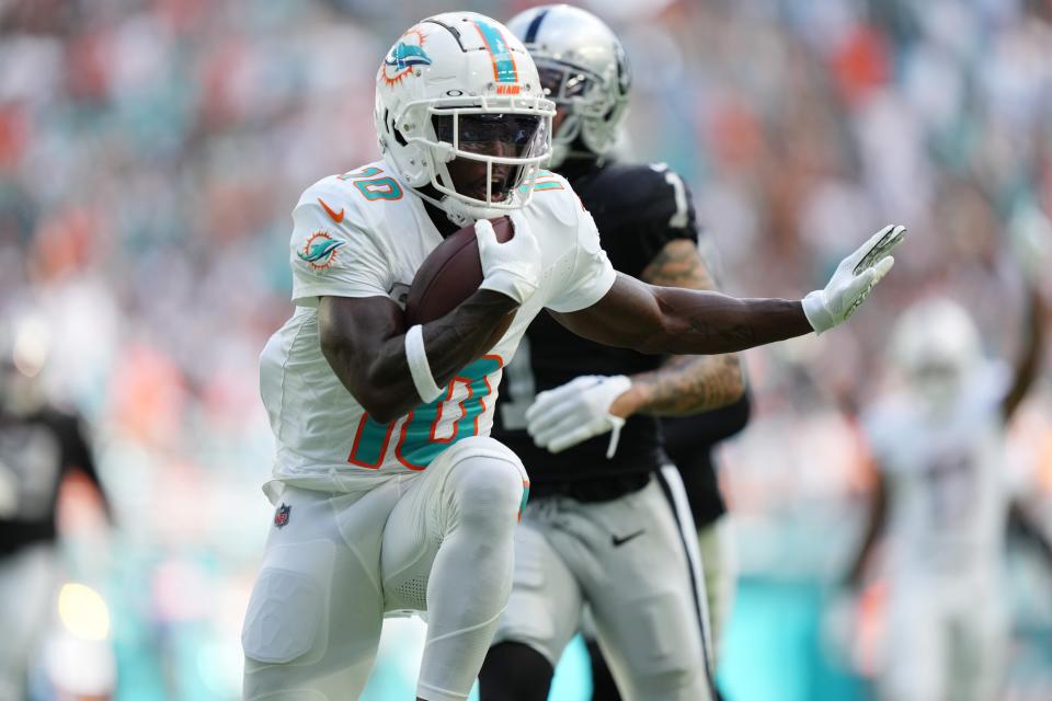 Miami Dolphins wide receiver Tyreek Hill (10) scores a touchdown during the first half of an NFL game against the Las Vegas Raiders at Hard Rock Stadium in Miami Gardens, Nov. 19, 2023.