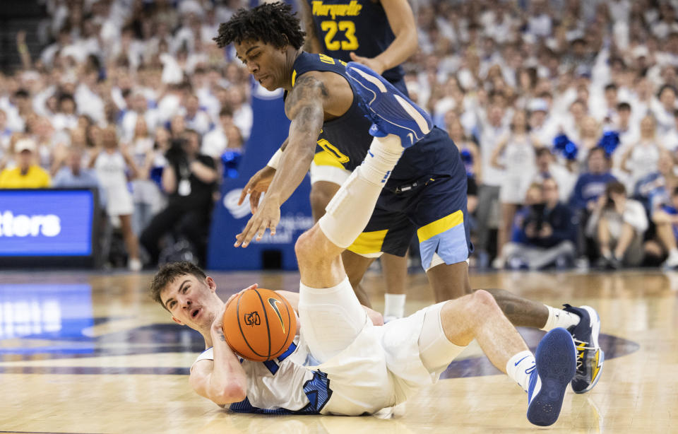 Creighton's Mason Miller, left, dives for a loose ball against Marquette's Zaide Lowery during the first half of an NCAA college basketball game Saturday, March 2, 2024, in Omaha, Neb. (AP Photo/Rebecca S. Gratz)