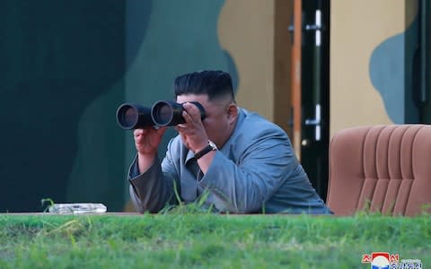  North Korean leader Kim Jong Un watches the test-fire of two short-range ballistic missiles - Credit: KCNA
