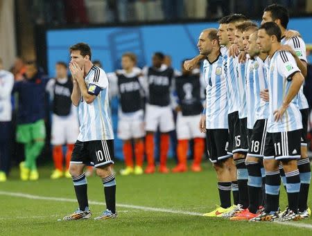 Argentina's Lionel Messi reacts next to teammates during a penalty shootout in their 2014 World Cup semi-finals against Netherlands at the Corinthians arena in Sao Paulo July 9, 2014. REUTERS/Darren Staples