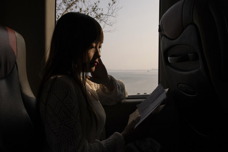 Emilia Wong catches up on reading letters from activist and partner Ventus Lau on her way back after visiting him at prison, in Hong Kong, Monday, March 25, 2024. For decades, Hong Kong's activists have been fighting for democracy. But a national security law imposed by Beijing in 2020 has dramatically changed their lives. In the city's biggest national security case, 47 democracy advocates were charged in 2021 over their roles in an unofficial primary election. (AP Photo/Louise Delmotte)