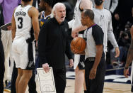 San Antonio Spurs head coach Gregg Popovich, front left, argues with referee Eric Lewis after the Spurs missed a shot to tie the contest late in the second half of an NBA basketball game against the Denver Nuggets, Friday, April 9, 2021, in Denver. (AP Photo/David Zalubowski)