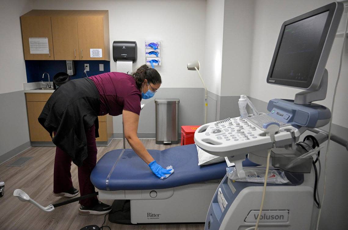 Amy Perez, a registered nurse who traveled from Texas to work at the new Planned Parenthood health center in Kansas City, Kansas, prepares an exam room for a patient.