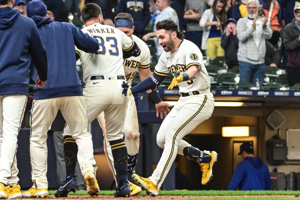 Apr 5, 2023; Milwaukee, Wisconsin, USA; Milwaukee Brewers left fielder Garrett Mitchell (5) is greeted by teammates after hitting the game-winning home run in the ninth inning against the New York Mets at American Family Field. Mandatory Credit: Benny Sieu-USA TODAY Sports