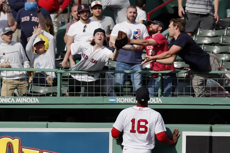 Boston Red Sox's Franchy Cordero (16) watches as fans reach for a solo home run by Los Angeles Angels' Brandon Marsh during the ninth inning of a baseball game, Thursday, May 5, 2022, in Boston. (AP Photo/Michael Dwyer)