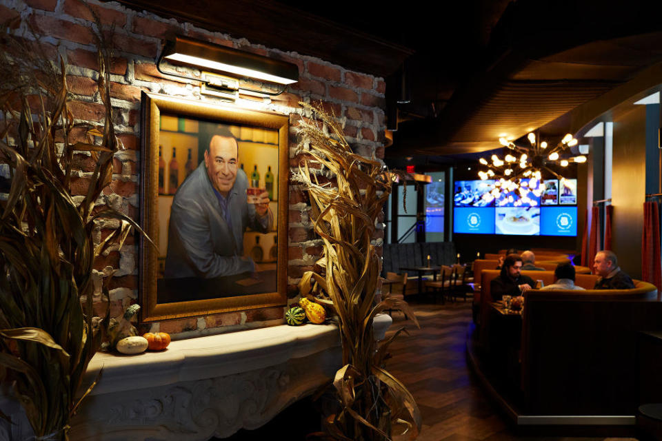 Portrait of Taffer on a log-paneled wall