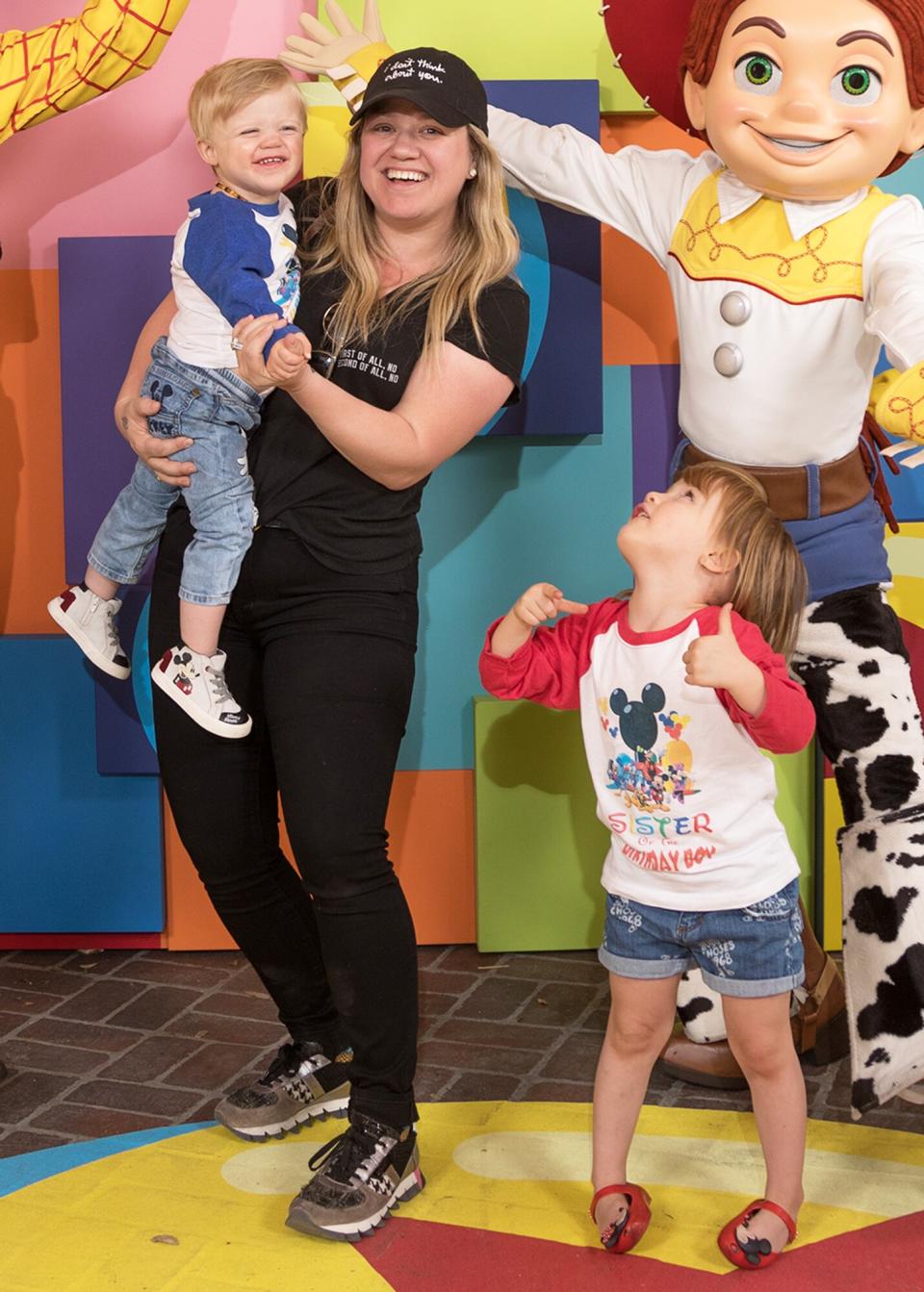 Kelly Clarkson and her children, Remington Alexander and River Rose, visit with Pixar pals Woody and Jessie at the launch of Pixar Fest at the Disneyland Resort in Anaheim, Calif., on Thursday. The first-ever Pixar Fest, the biggest Pixar celebration ever to come to Disney Parks, continues through Sept. 3, 2018