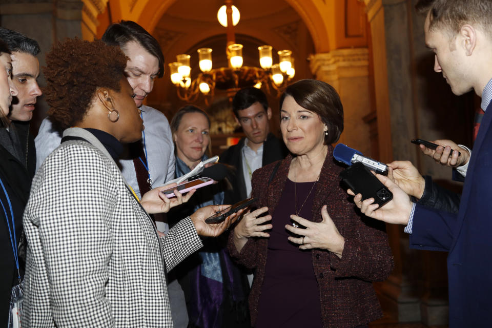 Sen. Amy Klobuchar, D-Minn., center, talks to reporters as she arrives at the Capitol in Washington, Wednesday, Jan. 22, 2020. The U.S. Senate plunges into President Donald Trump's impeachment trial with Republicans abruptly abandoning plans to cram opening arguments into two days but solidly rejecting for now Democratic demands for more witnesses to expose what they deem Trump's "trifecta" of offenses. Trump himself claims he wants top aides to testify, but qualified that by suggesting there were "national security" concerns to allowing their testimony. (AP Photo/Julio Cortez)