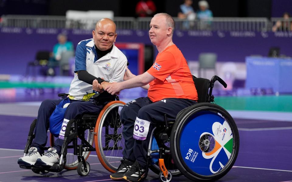 GB's Stephen McGuire and Colombia's Edilson Chica Chica shake hands ahead of their Boccia gold medal match