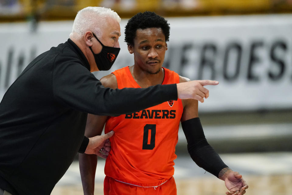 FILE - Oregon State head coach Wayne Tinkle, left, confers with guard Gianni Hunt in the first half of an NCAA college basketball game against Colorado on Feb. 8, 2021, in Boulder, Colo. Tinkle will be rooting for Gianni Hunt, a junior guard at Sacramento State who left Oregon State's program earlier this year. Hunt sought a fresh start after his playing time failed to develop as he had hoped. He took a leave of absence from the Beavers last season when his "love for the game had deteriorated," he said. (AP Photo/David Zalubowski, File)