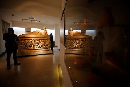 A visitor takes a picture with his mobile phone during the reopening of Syria's National Museum of Damascus, Syria October 28, 2018. REUTERS/Omar Sanadiki