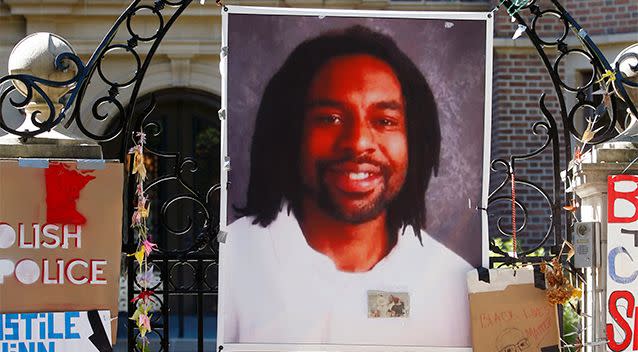 A photo of Philando Castile hanging on the gate of the governor's residence at Saint Paul Minnesota. Photo: AP