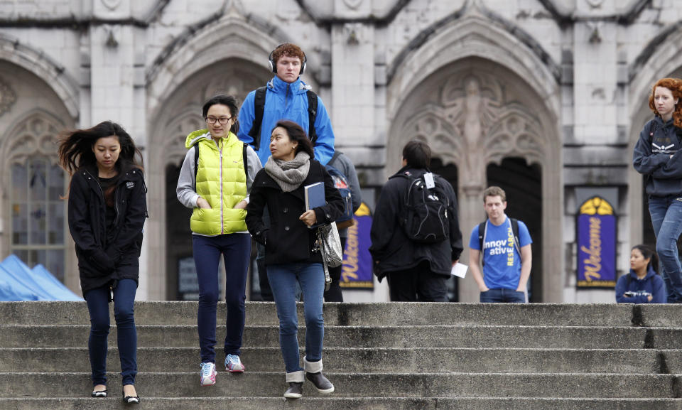 University of Washington students walk on the campus between classes Tuesday, Oct. 23, 2012, in Seattle. The university has about a thousand more international students on the campus this fall, but university officials say that doesn't mean they have cut back on the number of in-state students at the state's most selective public university. (AP Photo/Elaine Thompson)